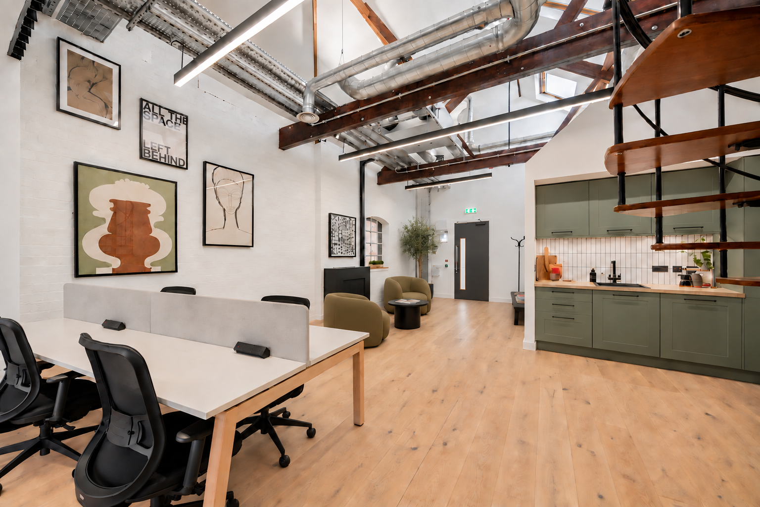 Queens Studios workspace with exposed beams and green cabinetry
